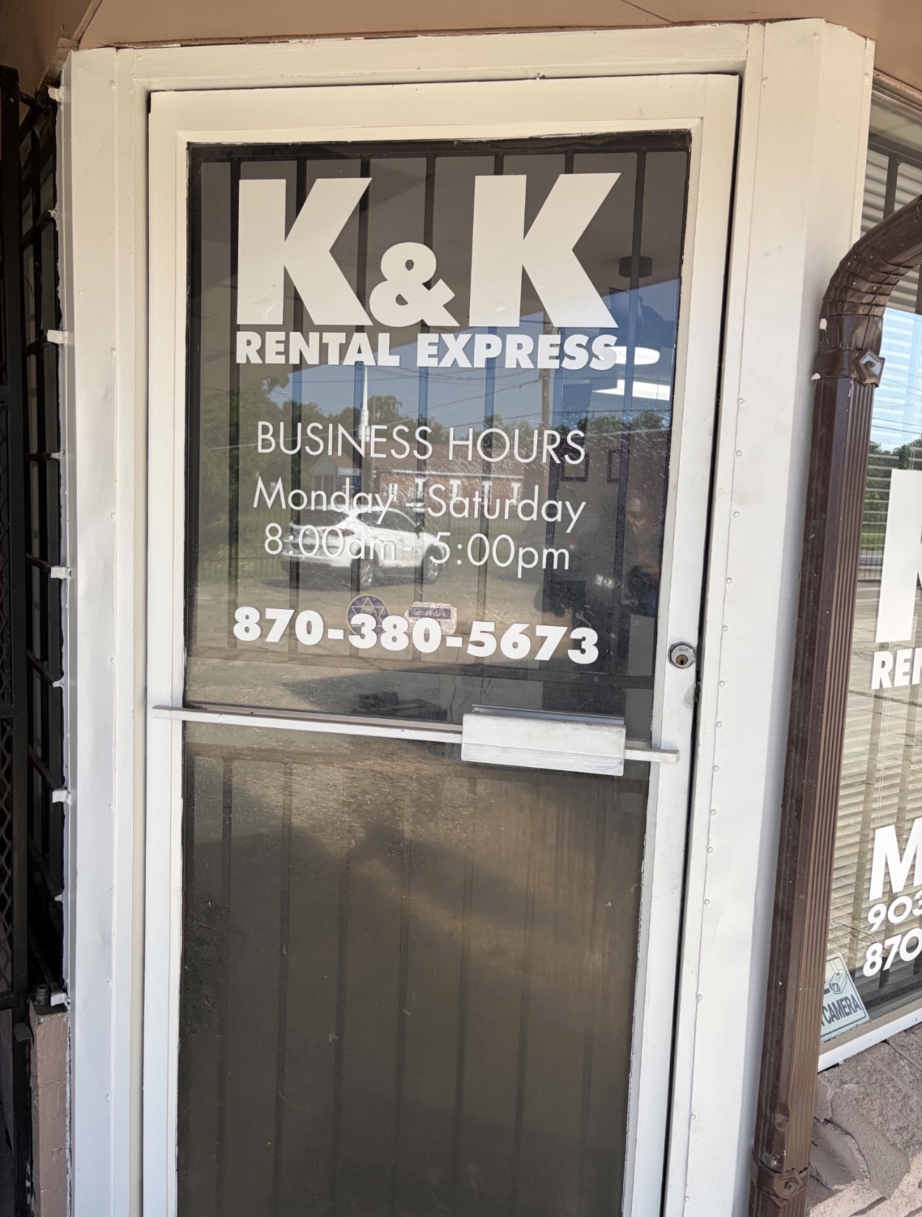 K&K Rental Express front door with business hours Monday through Saturday, 8:00am to 5:00pm